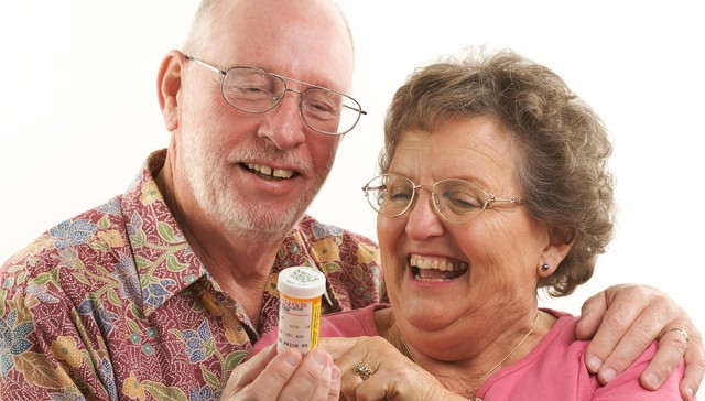 A Couple Reading a Prescription Bottle